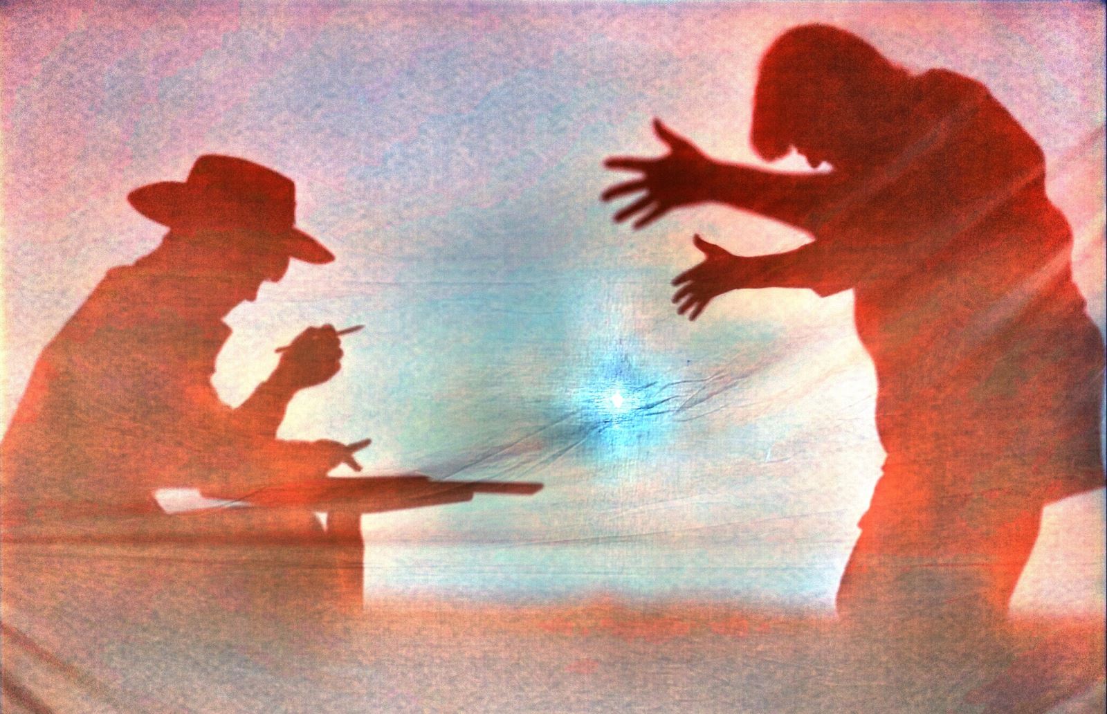 shadows of two men, one with a cowboy hat holding a pencil sitting at a table and the other with a pompadour haircut dancing